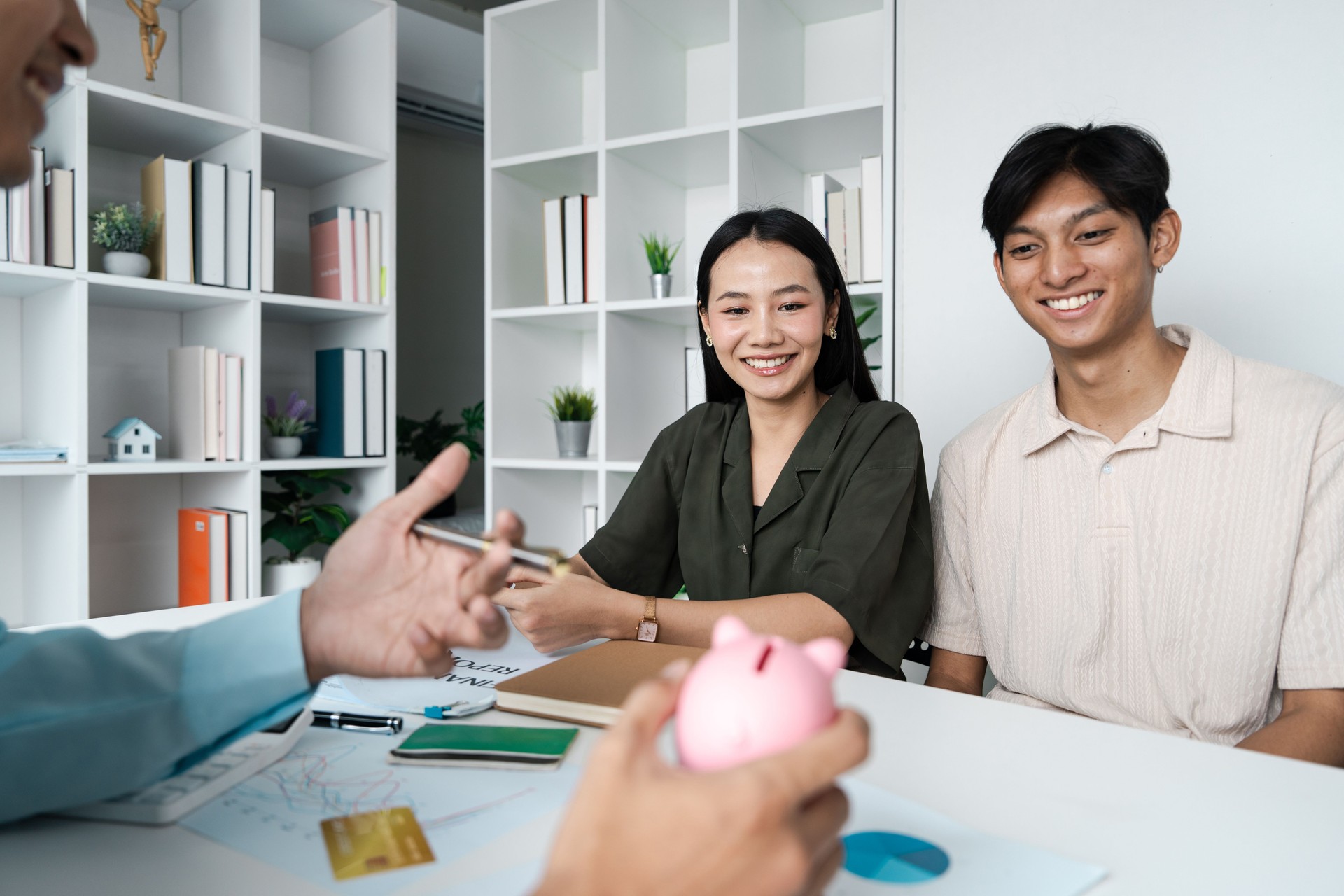 Young Couple Discussing Investment Plans with Financial Planner in Modern Office Setting